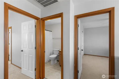 a view of a bathroom from a hallway