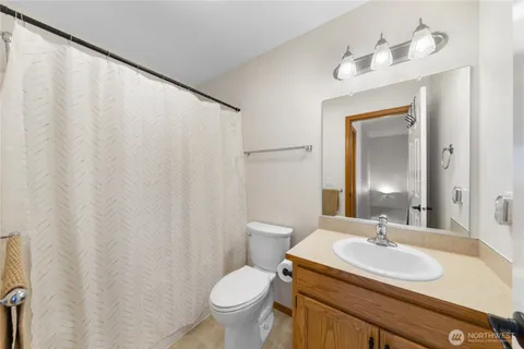a bathroom with a sink toilet and mirror