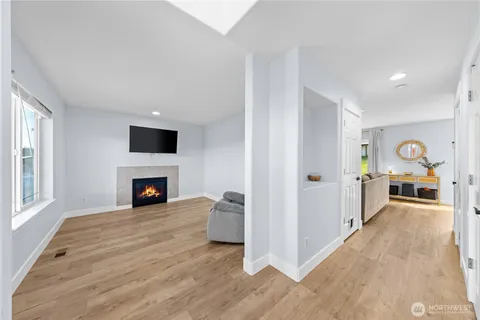 a view of a livingroom with a fireplace cabinet and window