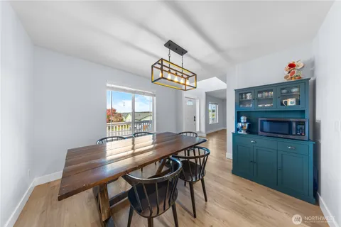 a view of a dining room with furniture and window