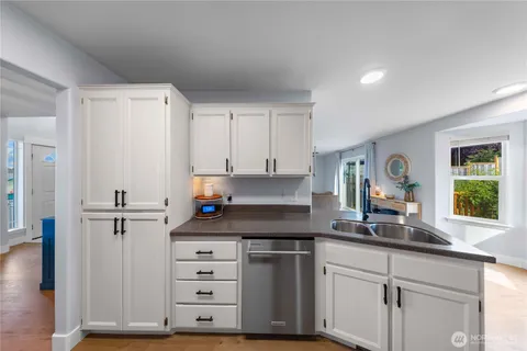 a kitchen with cabinets appliances and a window
