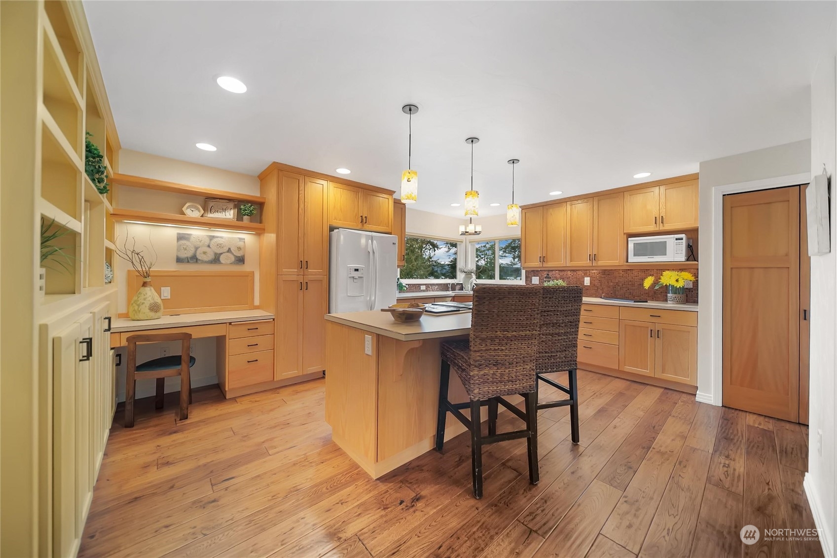 3217 West Sequim Bay Road Sequim, WA 98382 - Photo 8 of 40 a kitchen with a table chairs refrigerator and cabinets