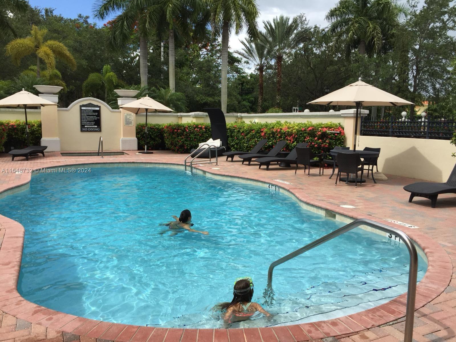 Kendall Miami, FL 33176 - Photo 6 of 15 a view of a backyard with lawn chairs under an umbrella