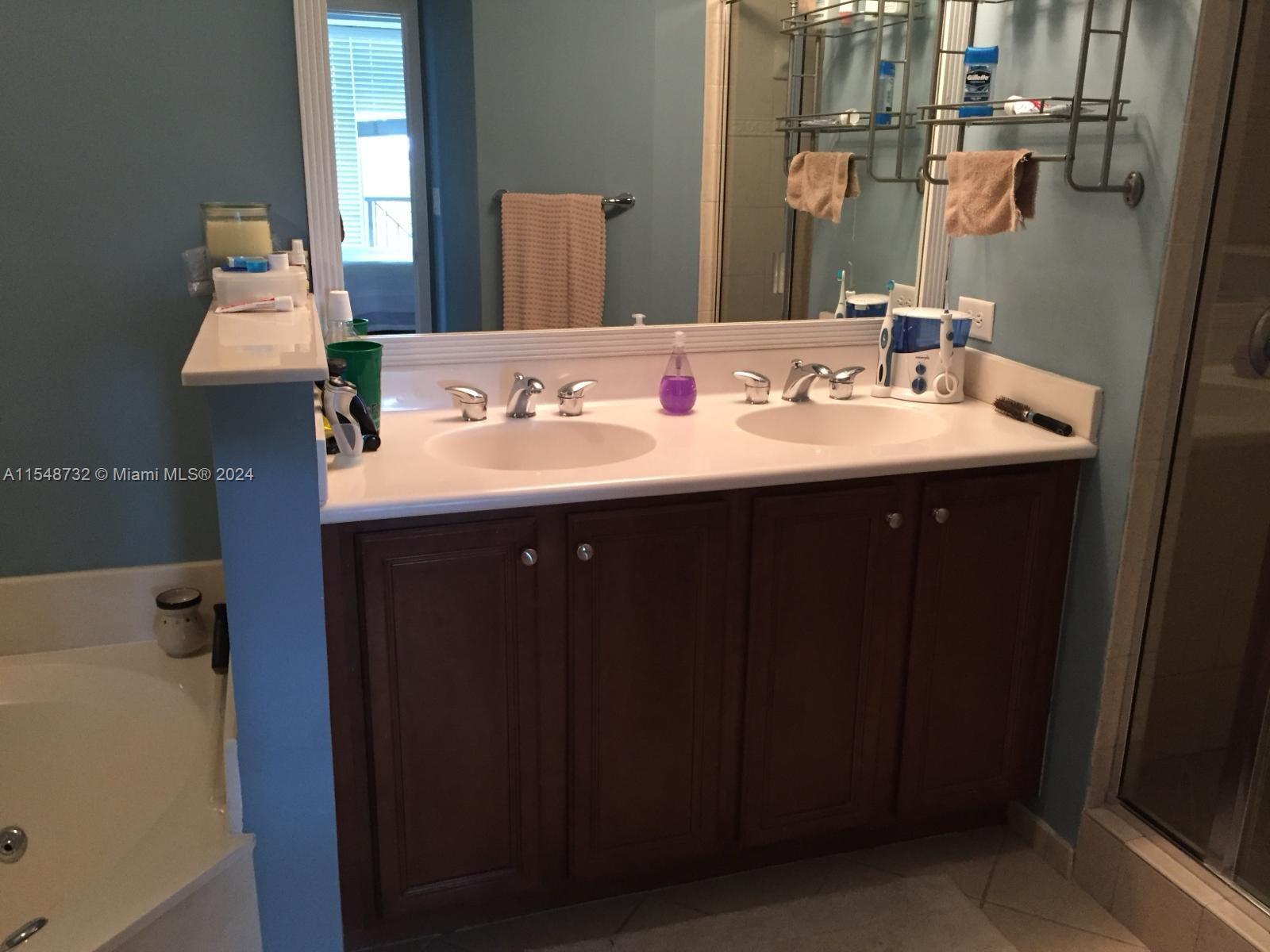 Kendall Miami, FL 33176 - Photo 7 of 15 a bathroom with a sink and a mirror