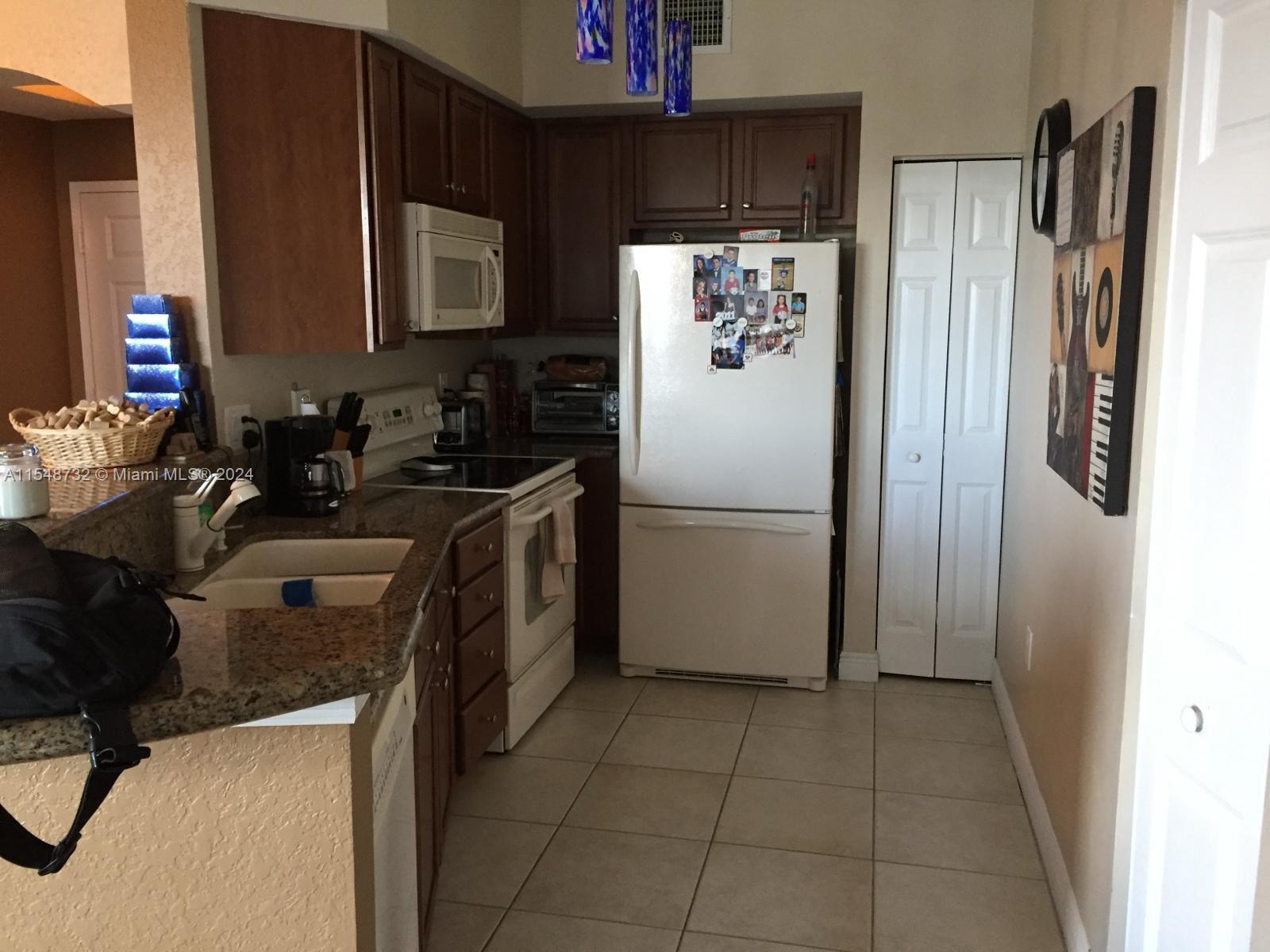 Kendall Miami, FL 33176 - Photo 10 of 15 a kitchen with a refrigerator sink and cabinets