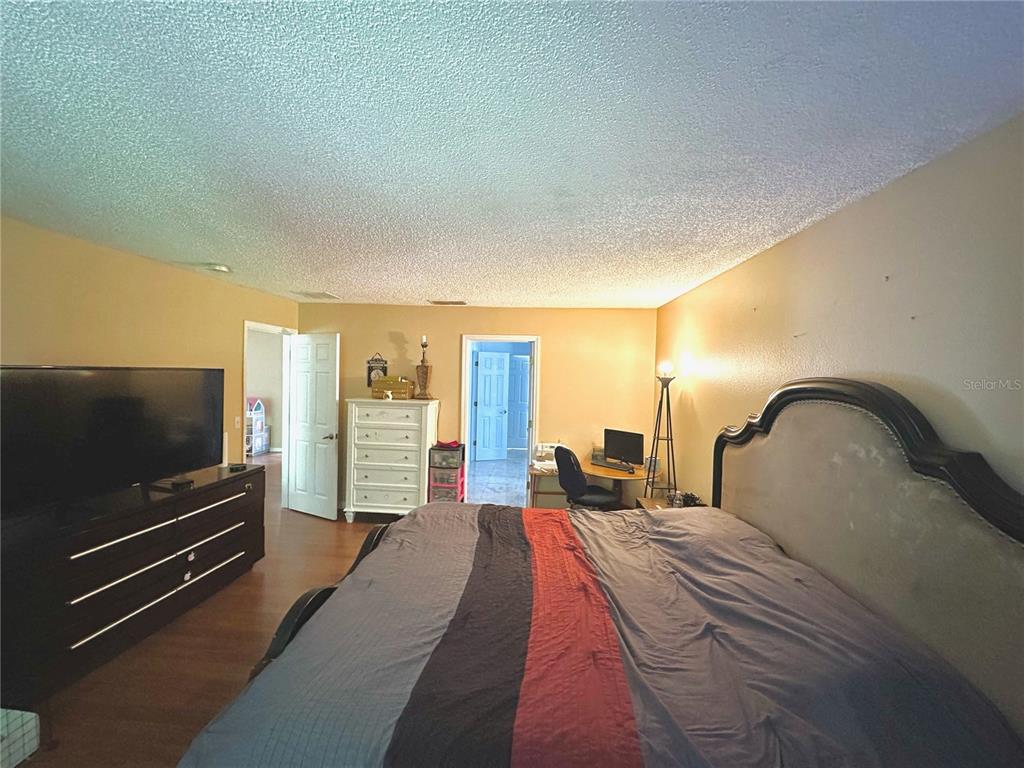 1225 Stone Harbour Road Winter Springs, FL 32708 - Photo 13 of 23 a bedroom with a bed and a flat screen tv