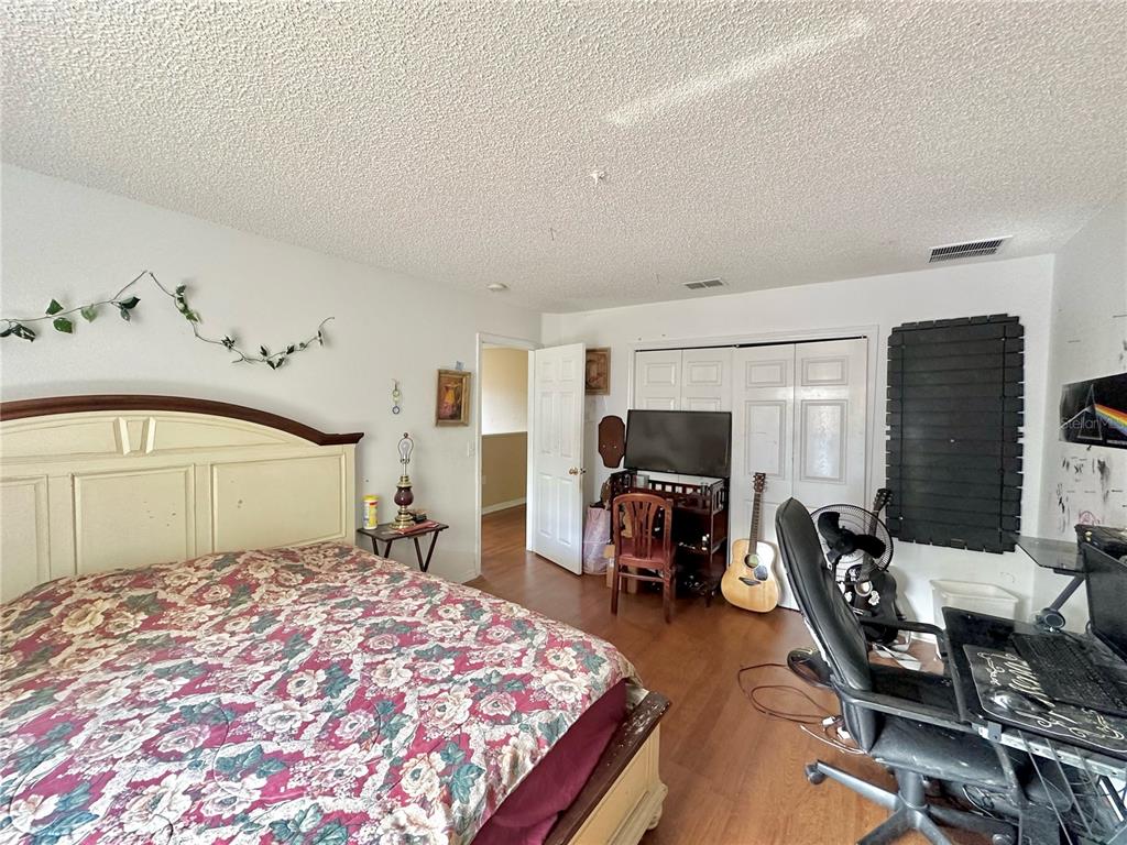 1225 Stone Harbour Road Winter Springs, FL 32708 - Photo 15 of 23 a bedroom with bed and glass door