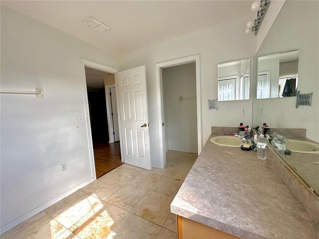 1225 Stone Harbour Road Winter Springs, FL 32708 - Photo 17 of 23 a view of a hallway with bathroom and mirror