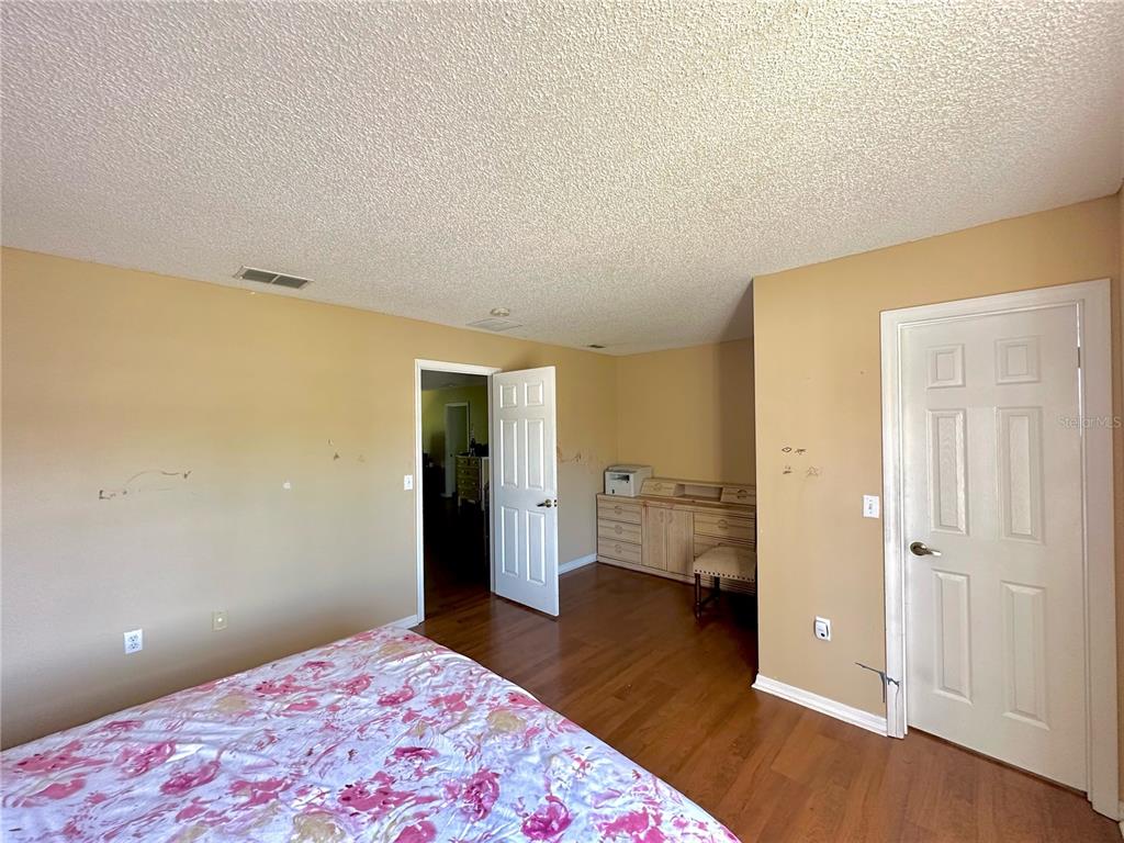 1225 Stone Harbour Road Winter Springs, FL 32708 - Photo 20 of 23 a bedroom with a bed and wooden floor