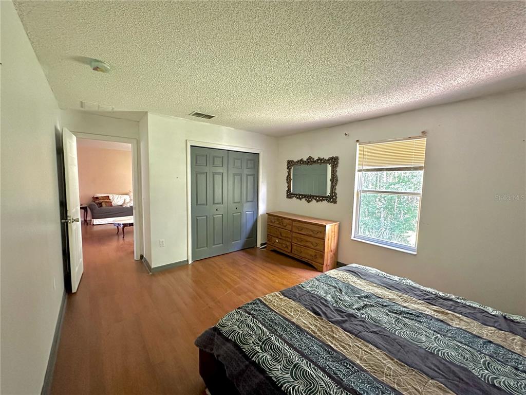 1225 Stone Harbour Road Winter Springs, FL 32708 - Photo 22 of 23 a bedroom with a bed and wooden floor