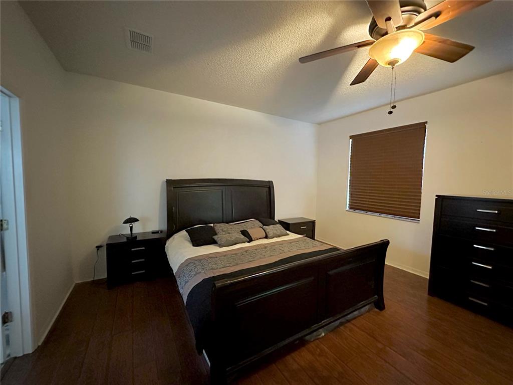 1225 Stone Harbour Road Winter Springs, FL 32708 - Photo 3 of 23 a bedroom with a bed and a chandelier