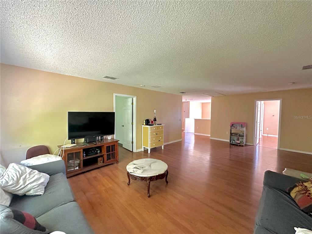 1225 Stone Harbour Road Winter Springs, FL 32708 - Photo 4 of 23 a living room with furniture and a flat screen tv