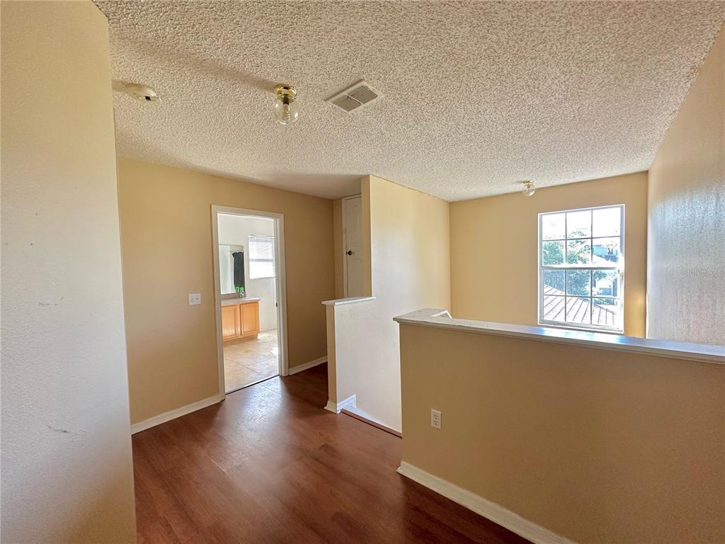 1225 Stone Harbour Road Winter Springs, FL 32708 - Photo 5 of 23 a view of an empty room with a window and wooden floor