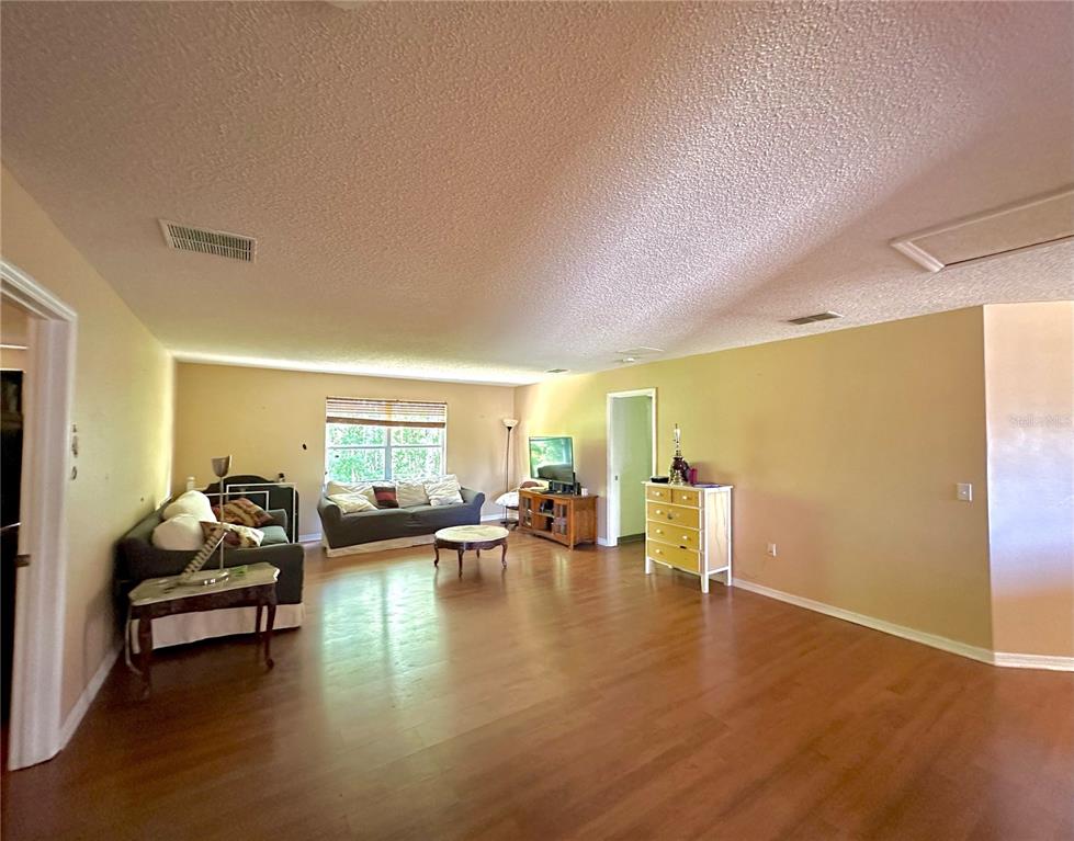1225 Stone Harbour Road Winter Springs, FL 32708 - Photo 6 of 23 a living room with furniture and a wooden floor