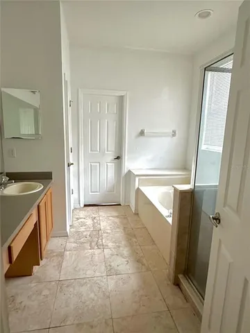 a bathroom with a tub shower and a sink