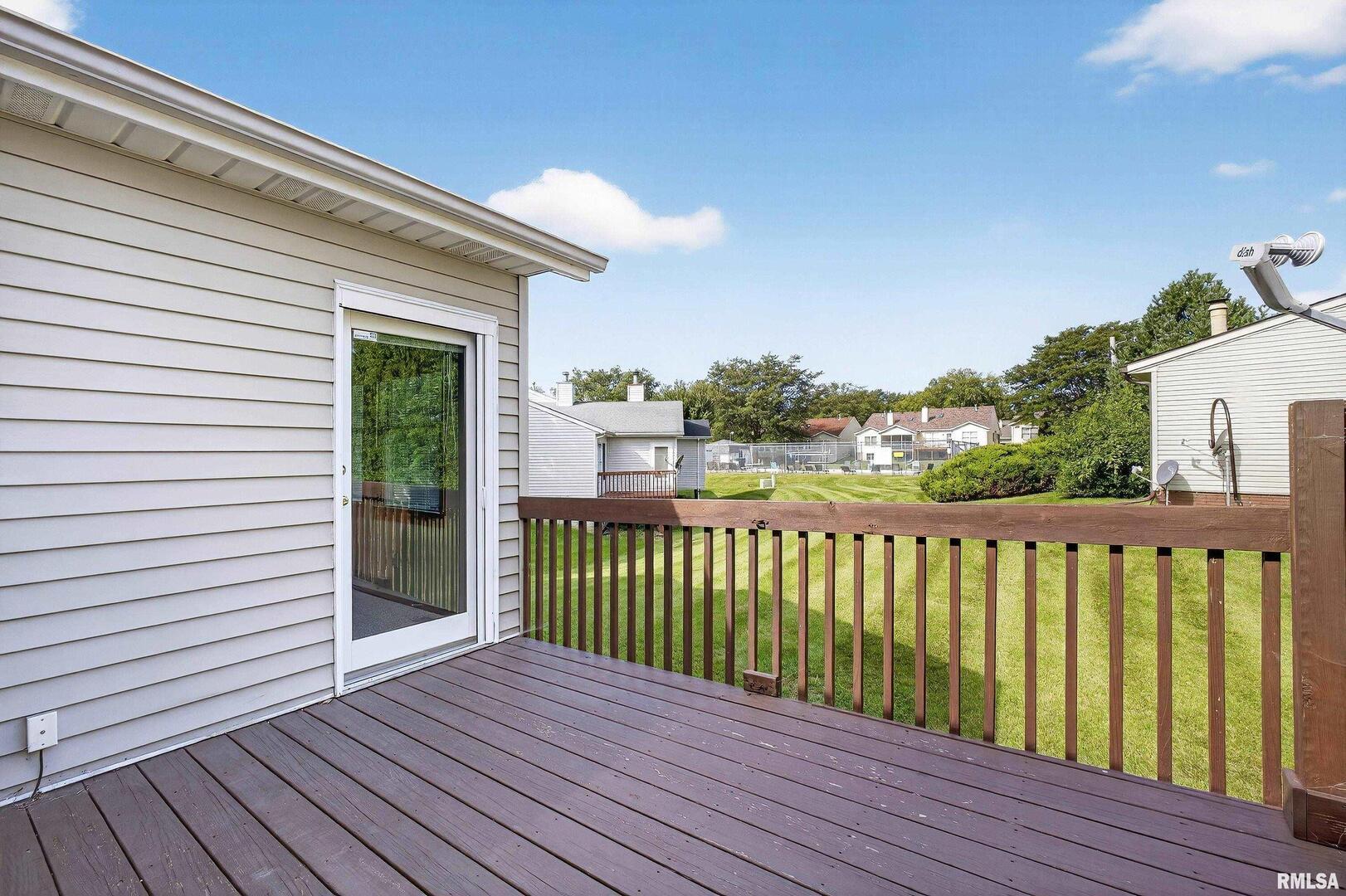 3988 Partridge Circle Bettendorf, IA 52722 - Photo 16 of 42 a view of a wooden deck with a yard