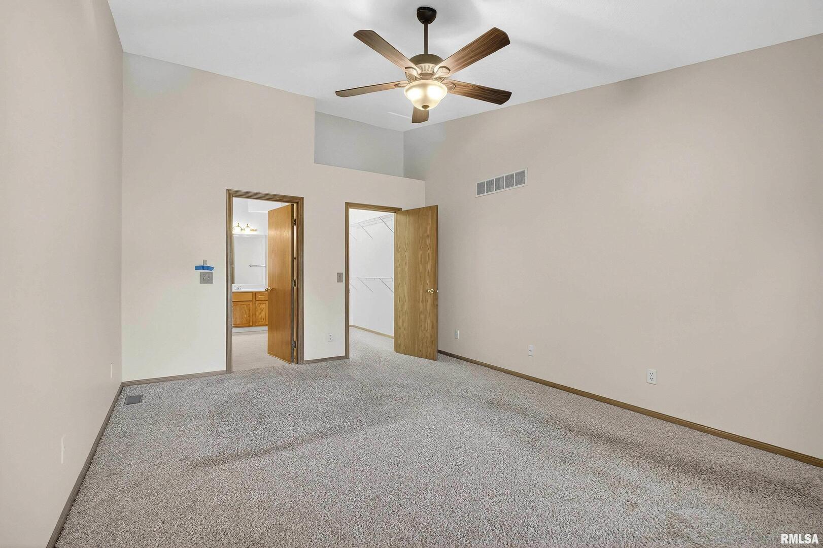 3988 Partridge Circle Bettendorf, IA 52722 - Photo 19 of 42 an empty room with closet and a ceiling fan