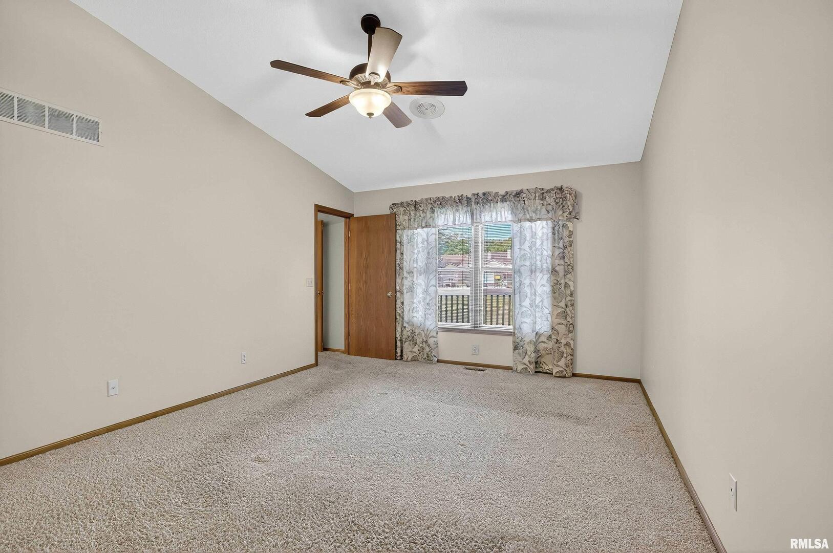3988 Partridge Circle Bettendorf, IA 52722 - Photo 20 of 42 an empty room with a ceiling fan and a window