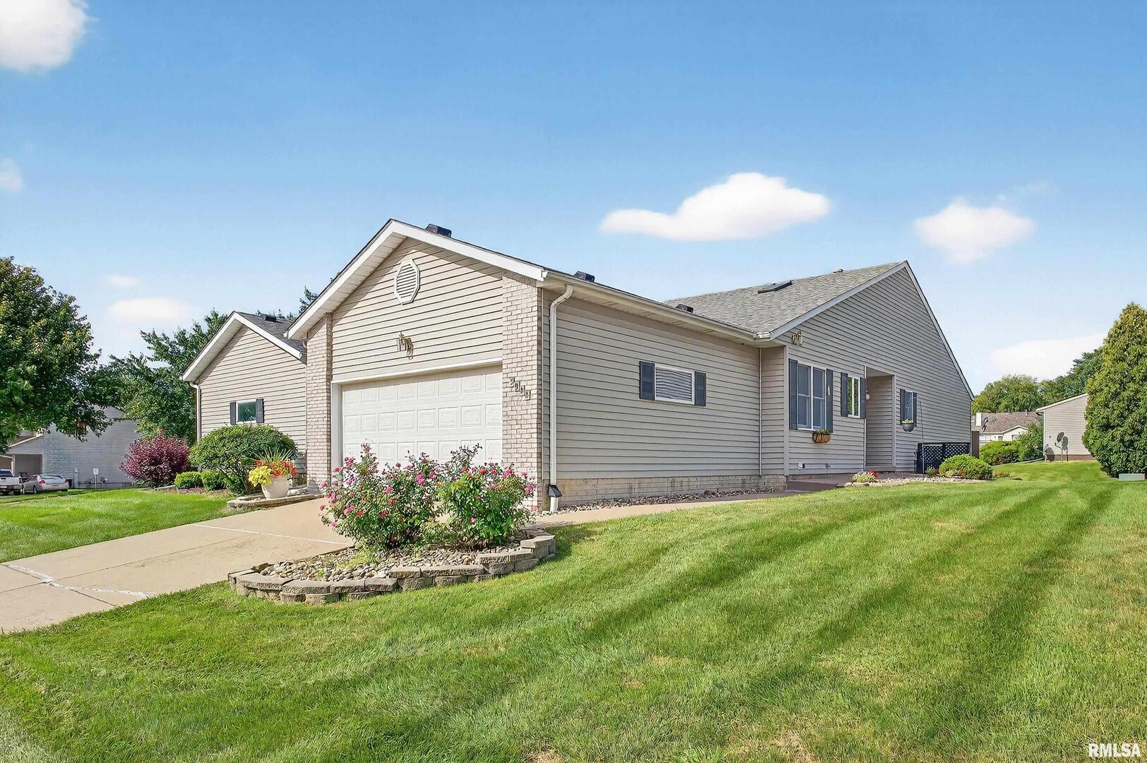 3988 Partridge Circle Bettendorf, IA 52722 - Photo 2 of 42 a front view of house with yard and green space