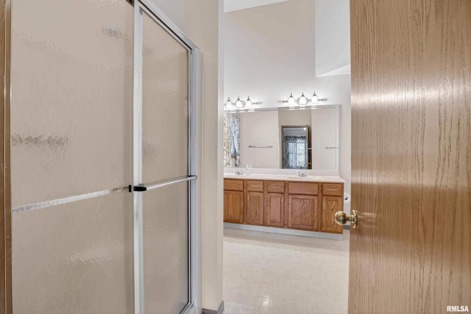 3988 Partridge Circle Bettendorf, IA 52722 - Photo 21 of 42 a bathroom with a double vanity sink mirror and shower