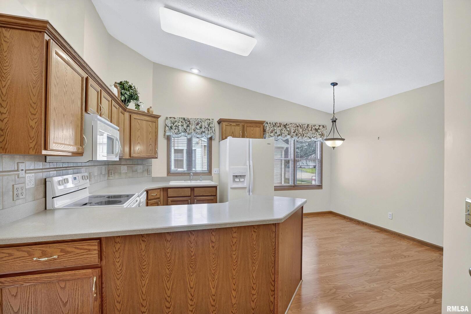3988 Partridge Circle Bettendorf, IA 52722 - Photo 24 of 42 a kitchen with stainless steel appliances granite countertop a sink and a refrigerator