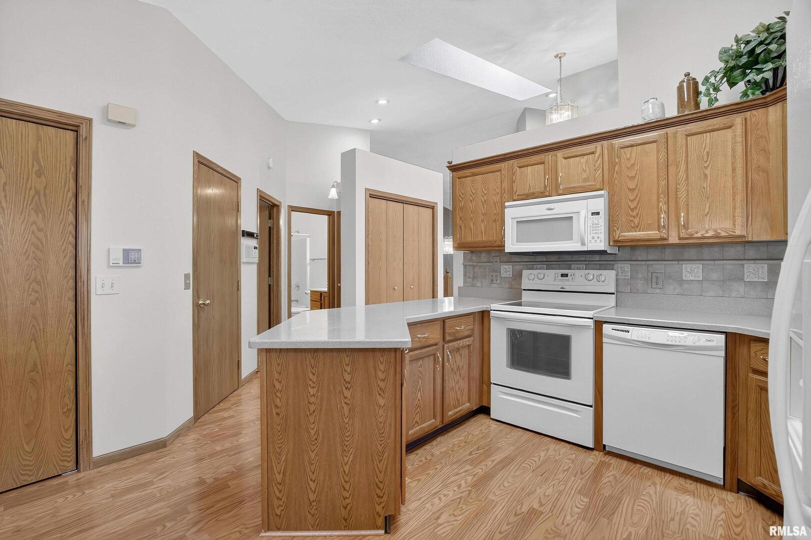 3988 Partridge Circle Bettendorf, IA 52722 - Photo 27 of 42 a kitchen with stainless steel appliances granite countertop a stove a sink and a refrigerator