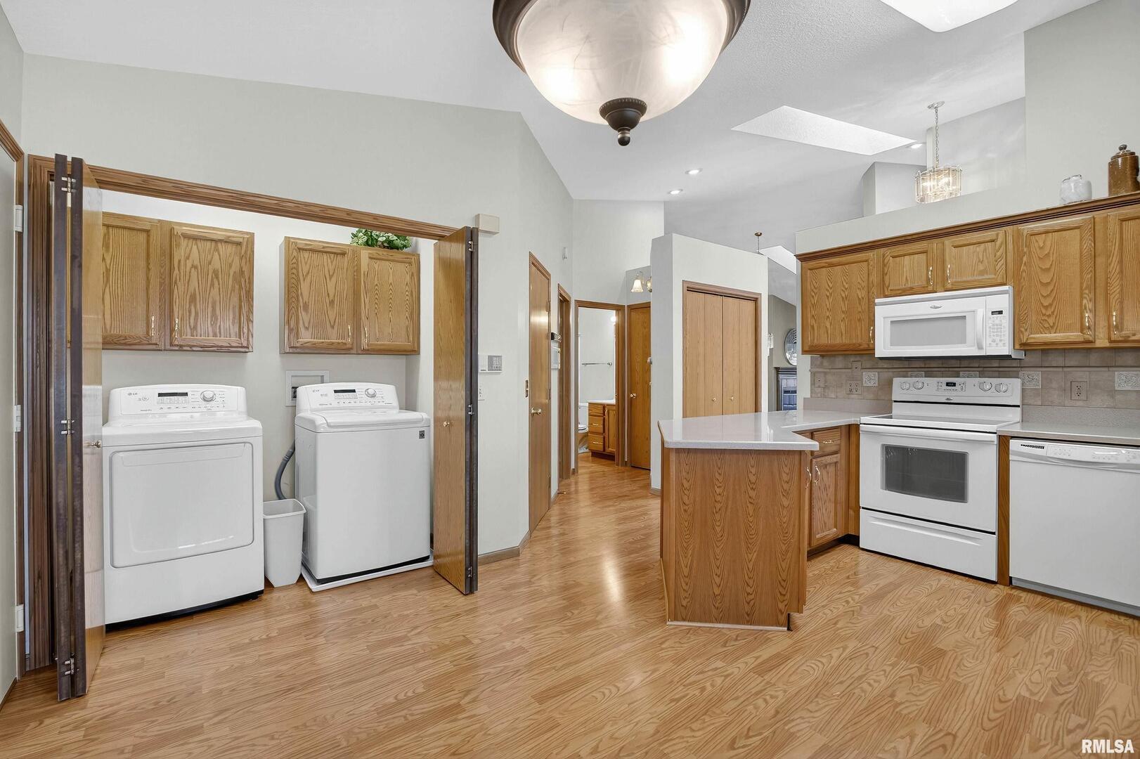 3988 Partridge Circle Bettendorf, IA 52722 - Photo 28 of 42 a kitchen with granite countertop white cabinets and white appliances