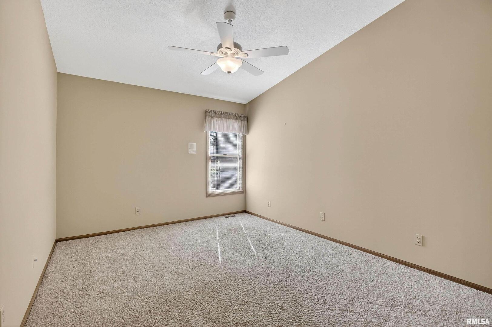 3988 Partridge Circle Bettendorf, IA 52722 - Photo 30 of 42 an empty room with windows and fan