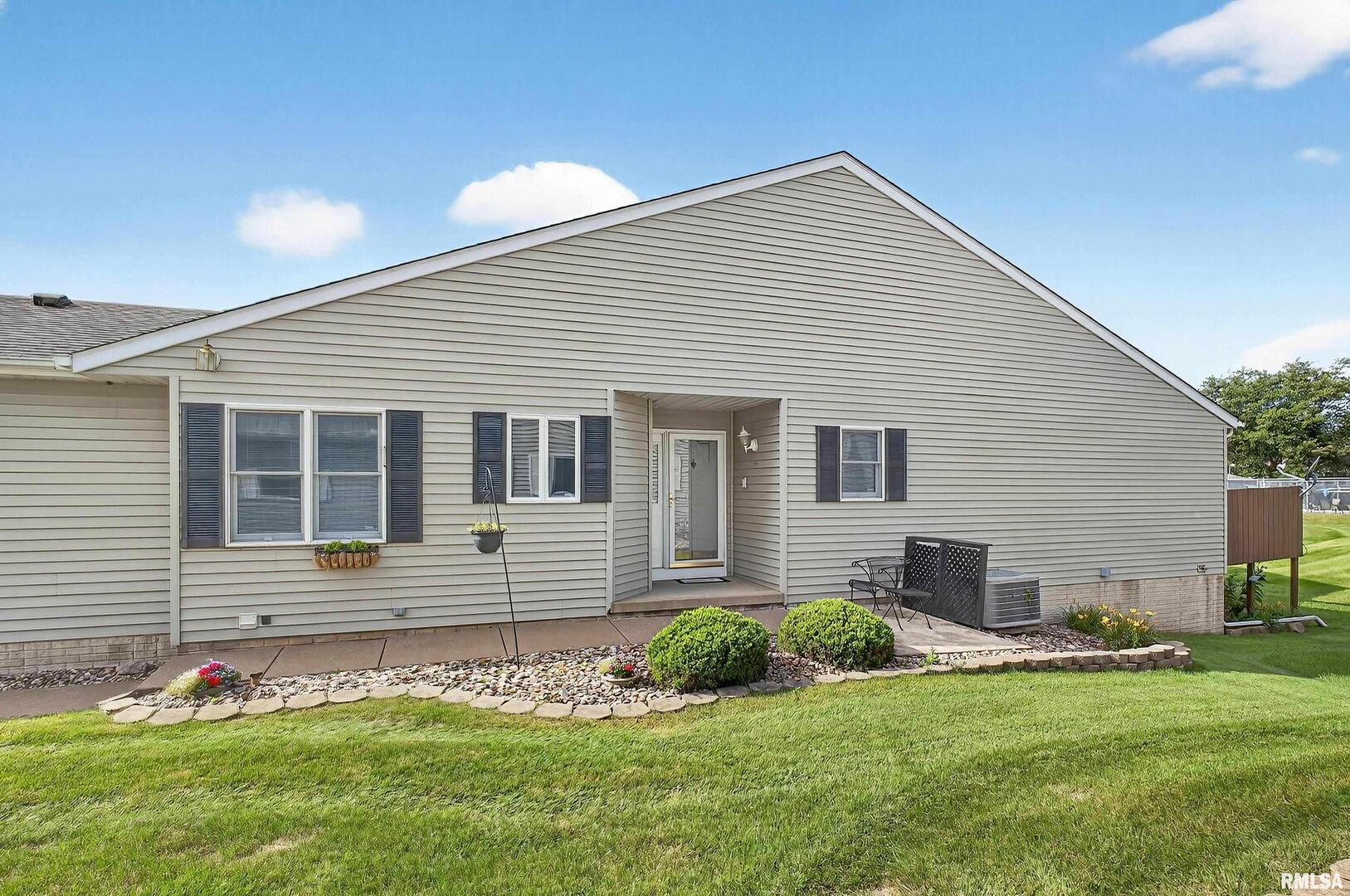 3988 Partridge Circle Bettendorf, IA 52722 - Photo 4 of 42 a front view of a house with a yard