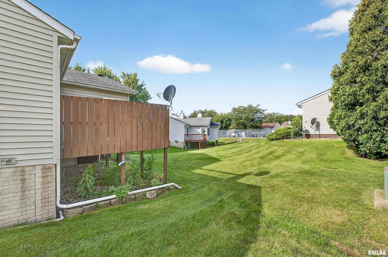 3988 Partridge Circle Bettendorf, IA 52722 - Photo 41 of 42 a view of a backyard with a garden and plants