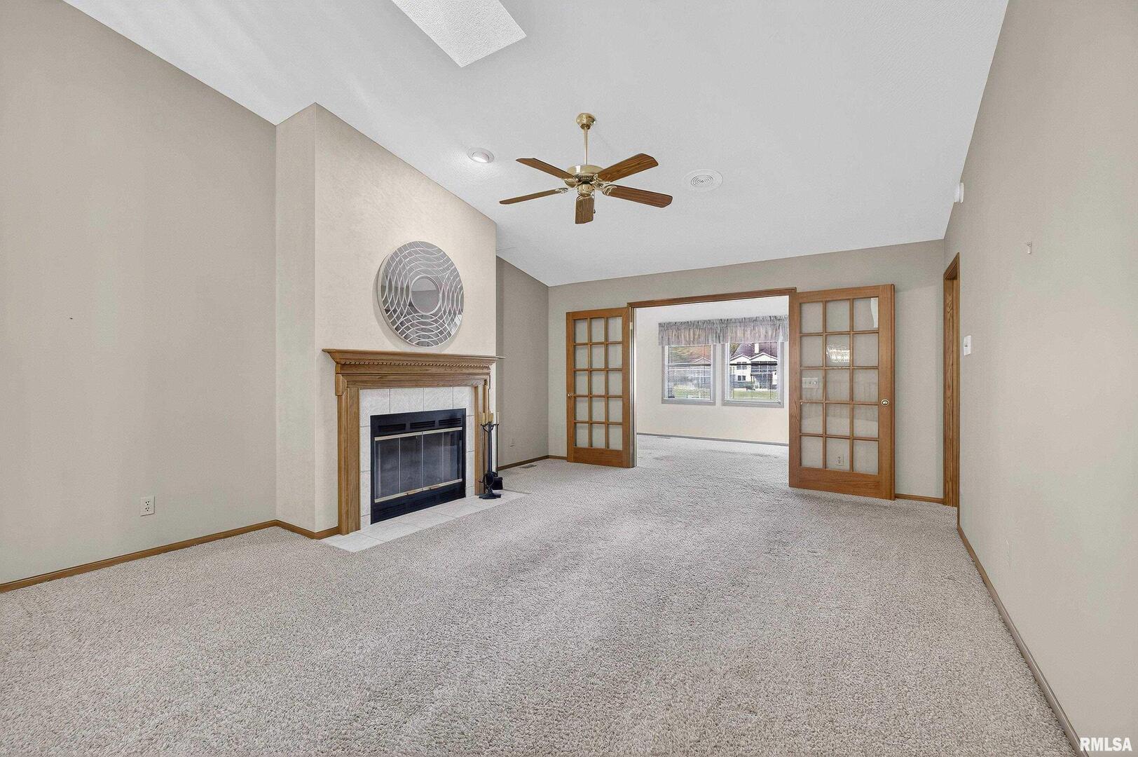3988 Partridge Circle Bettendorf, IA 52722 - Photo 9 of 42 a view of an empty room with a fireplace and a window