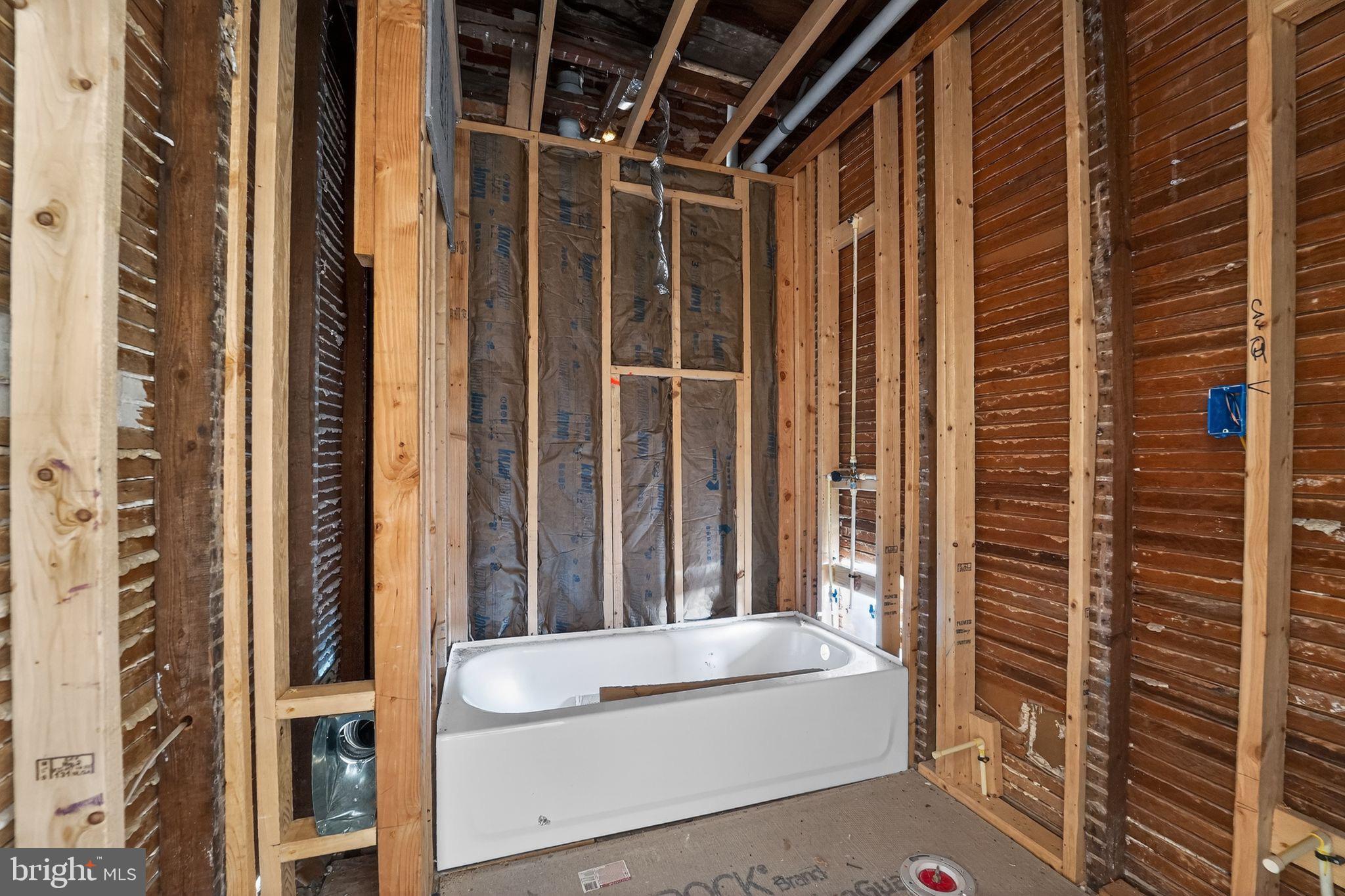 900 North Franklintown Road Baltimore, MD 21216 - Photo 15 of 16 a bathroom with a bathtub and shower