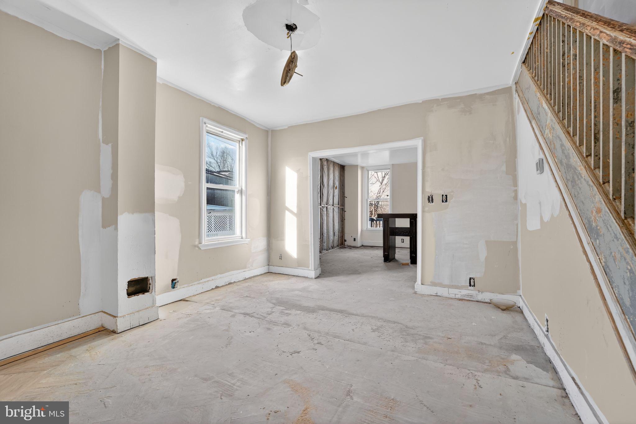 900 North Franklintown Road Baltimore, MD 21216 - Photo 5 of 16 a view of empty room with wooden floor and windows
