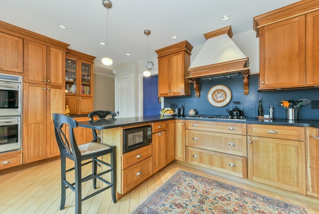 47 Standish Road Milton, MA 02186 - Photo 9 of 23 a kitchen with stainless steel appliances granite countertop a stove and a refrigerator
