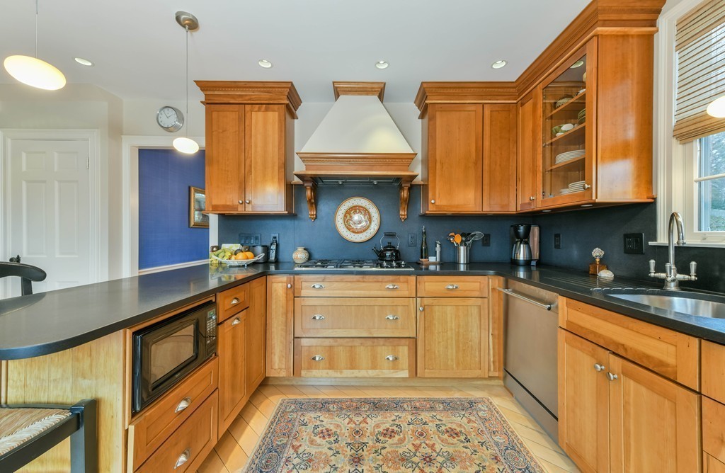 47 Standish Road Milton, MA 02186 - Photo 10 of 23 a kitchen with wooden cabinets and a stove top oven