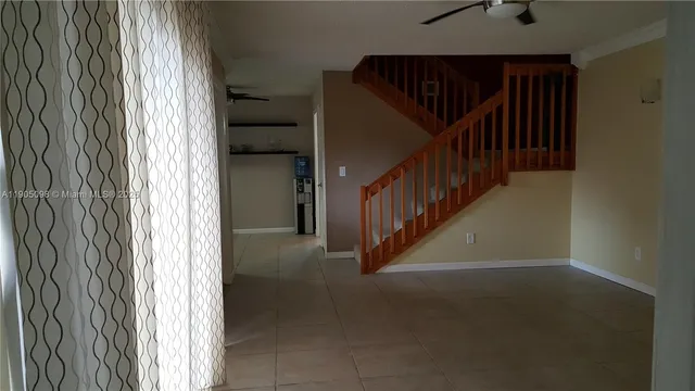 a view of a hallway with stairs