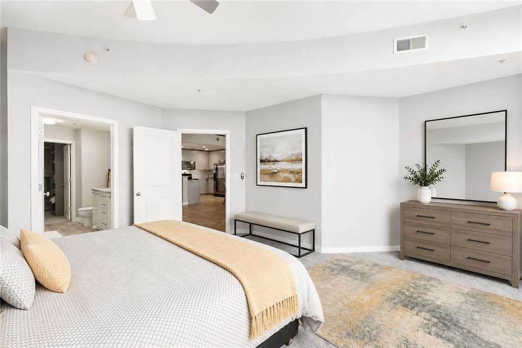3300 Windy Ridge Parkway Southeast, Unit 1112 Atlanta, GA 30339 - Photo 21 of 43 a bedroom with a bed and a dresser