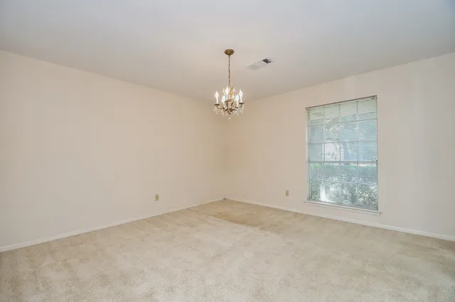 an empty room with windows and entrance