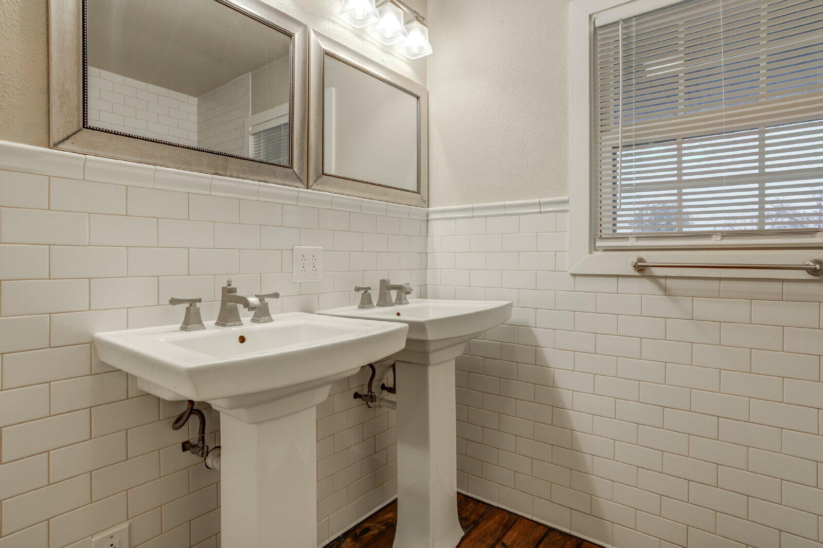 3415 27th Street Lubbock, TX 79410 - Photo 20 of 30 a bathroom with a sink a mirror and a shower