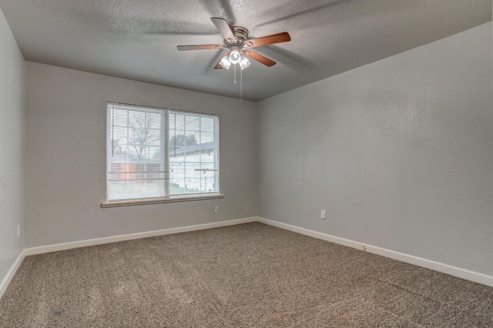 3415 27th Street Lubbock, TX 79410 - Photo 21 of 30 an empty room with windows and fan