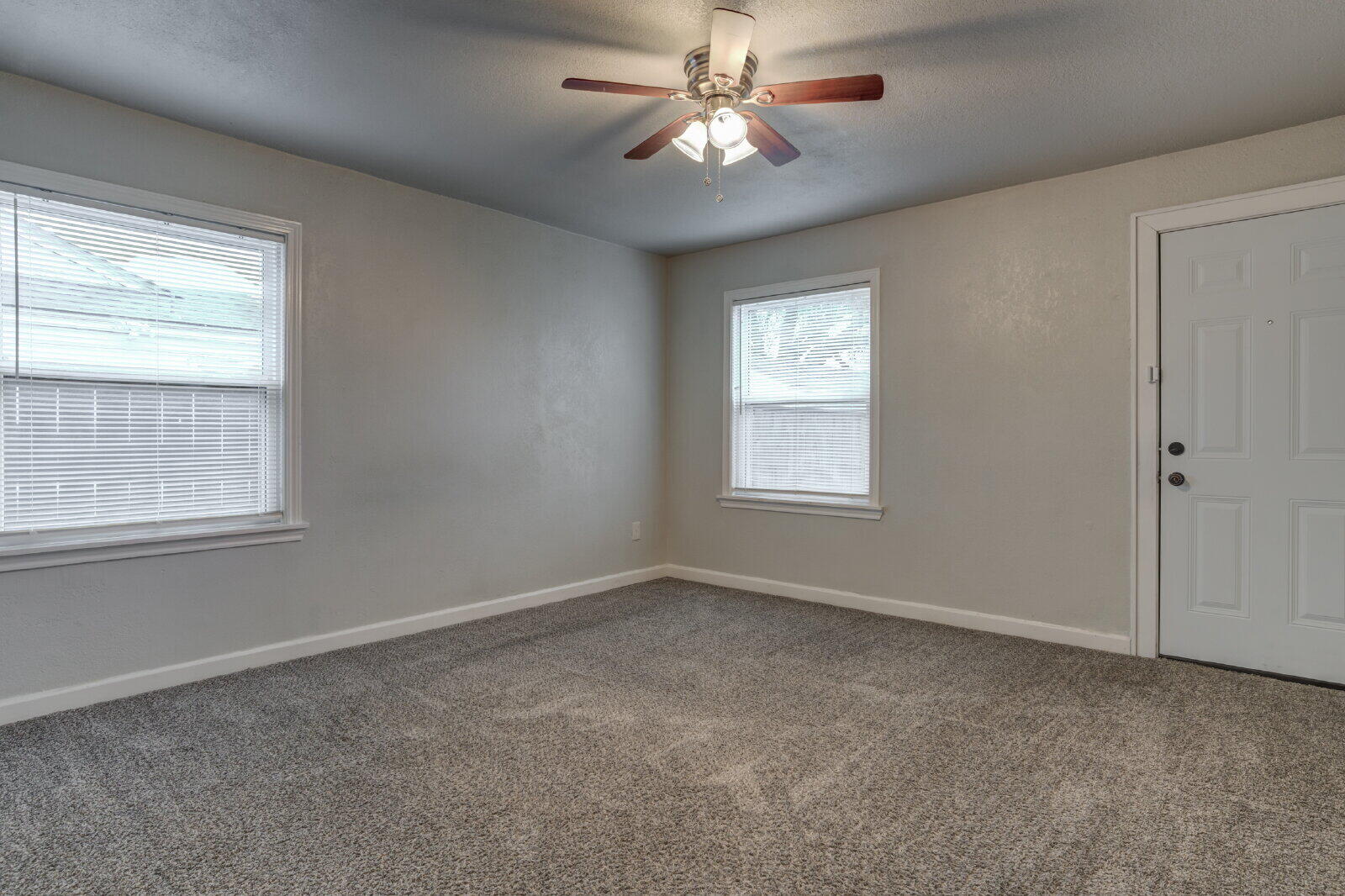 3415 27th Street Lubbock, TX 79410 - Photo 23 of 30 an empty room with windows and fan