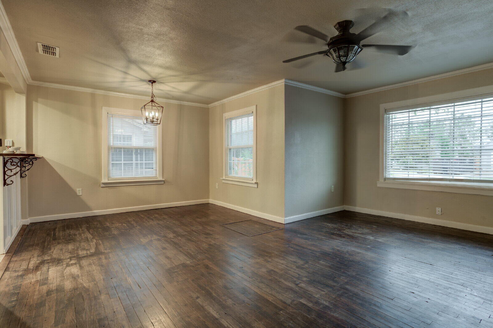 3415 27th Street Lubbock, TX 79410 - Photo 6 of 30 a view of an empty room with a window and wooden floor