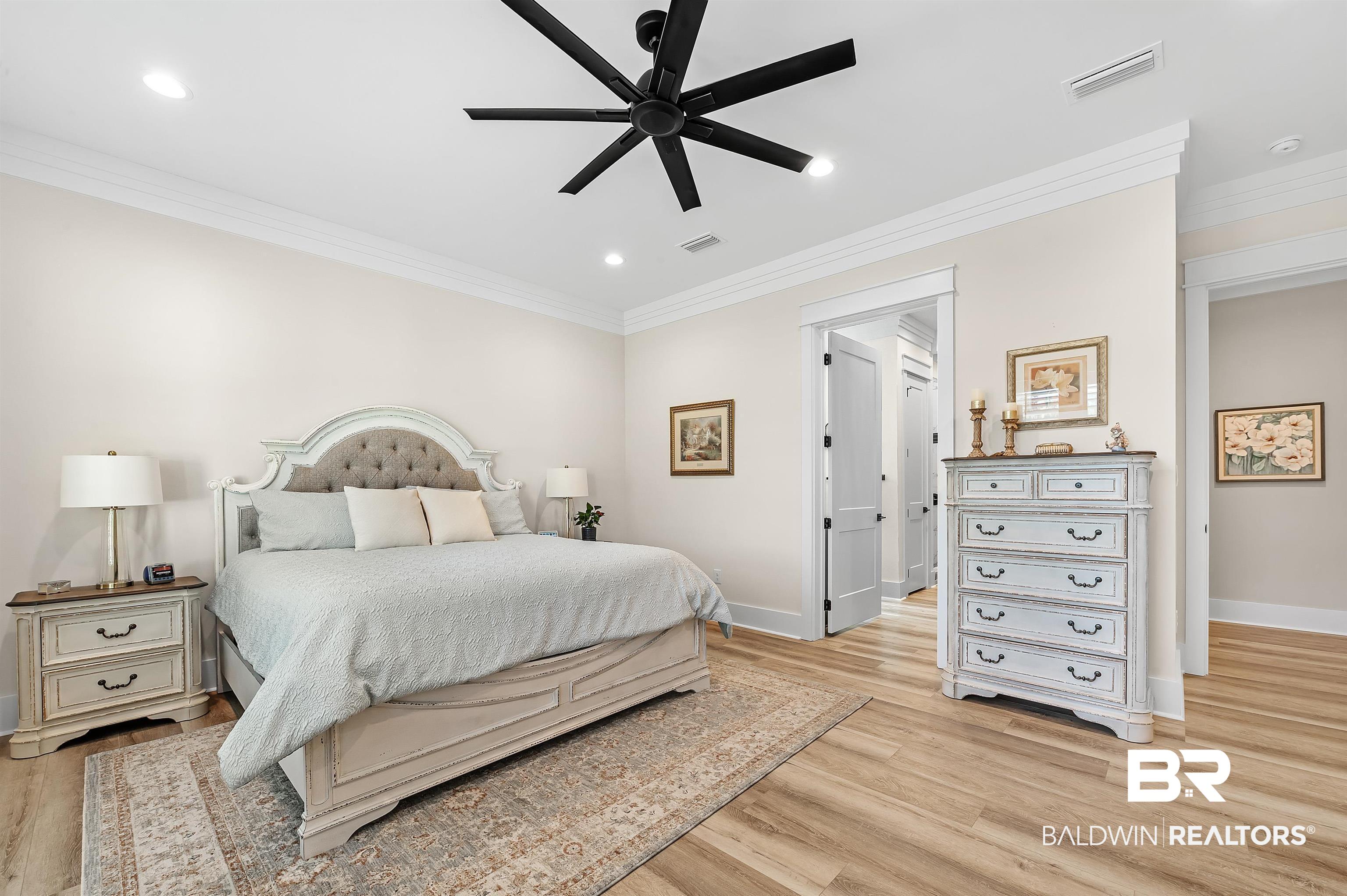 9144 Harvest Ridge Fairhope, AL 36532 - Photo 29 of 58 Bedroom featuring crown molding, baseboards, light wood finished floors, and visible vents
