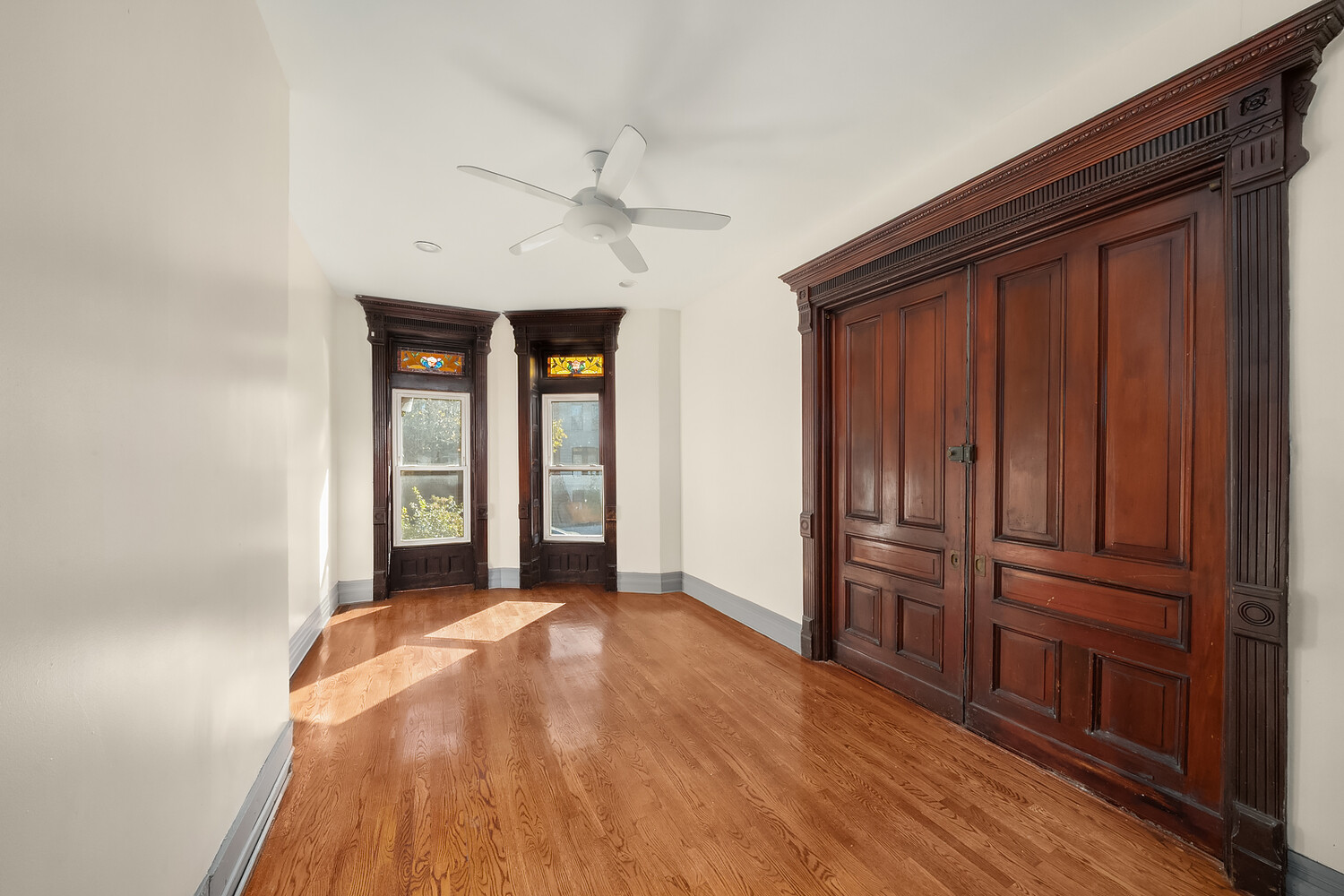 497 Decatur Street Brooklyn, NY 11233 - Photo 9 of 21 wooden floor and windows in a room
