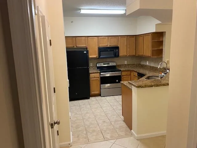a kitchen with stainless steel appliances a refrigerator and a stove