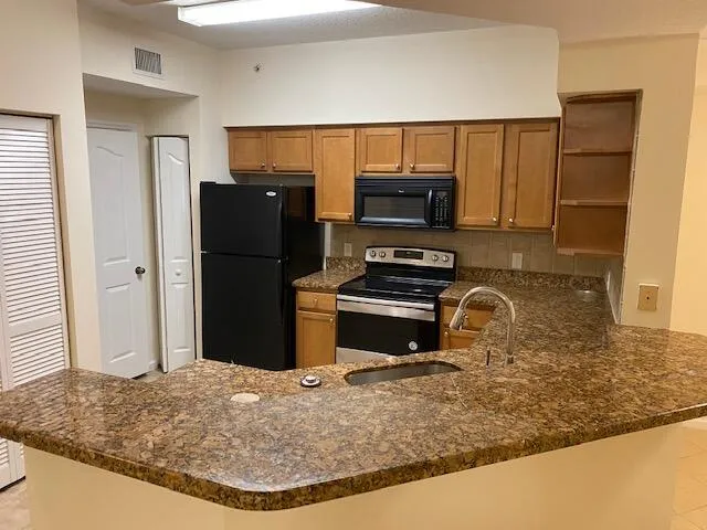 a kitchen with a refrigerator sink and microwave