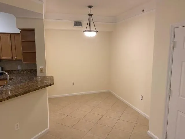 a view of a kitchen with a sink and chandelier