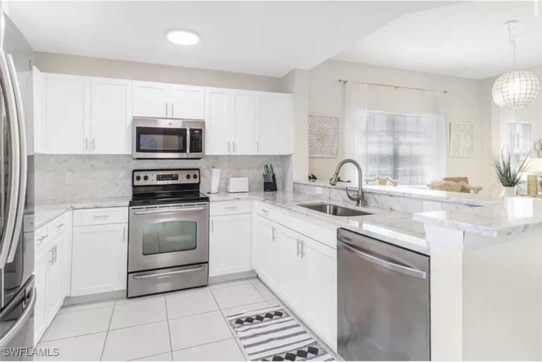 a kitchen with kitchen island granite countertop a sink stove and microwave