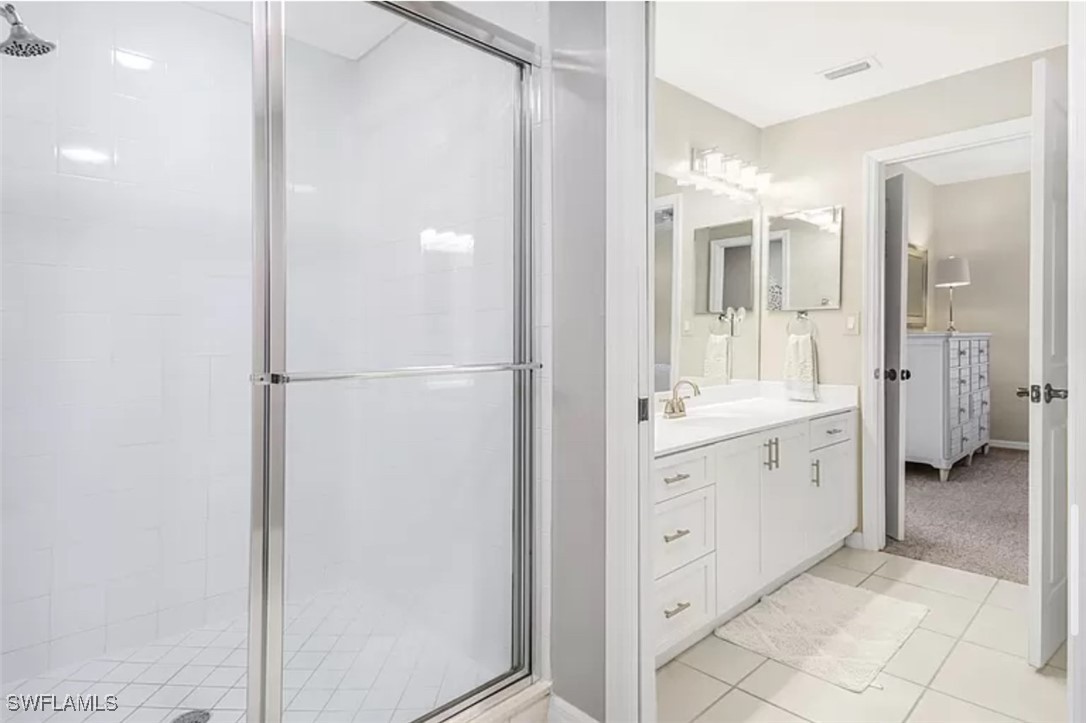 4450 Botanical Pl Circle, Unit 6 Naples, FL 34112 - Photo 12 of 33 a spacious bathroom with a shower and a sink