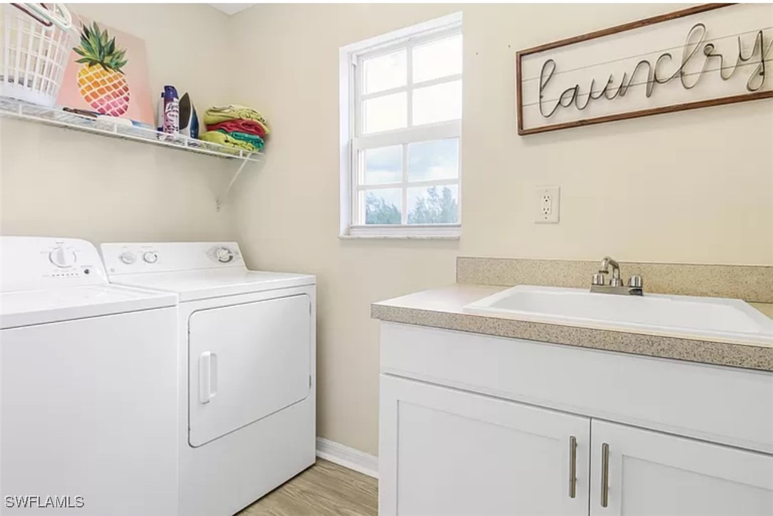 4450 Botanical Pl Circle, Unit 6 Naples, FL 34112 - Photo 17 of 33 a utility room with dryer and washer